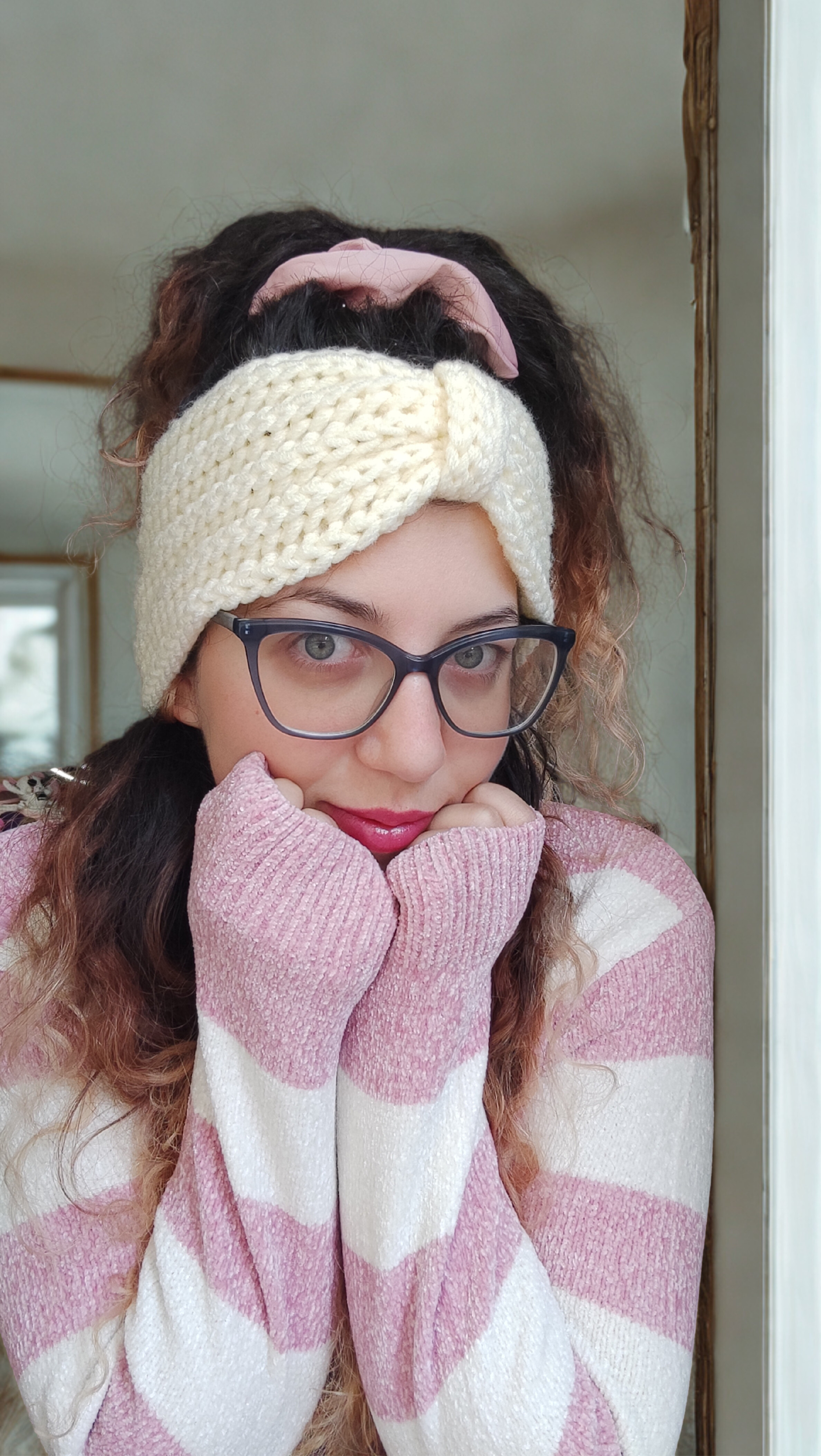 Person wearing a cream crochet headband, 