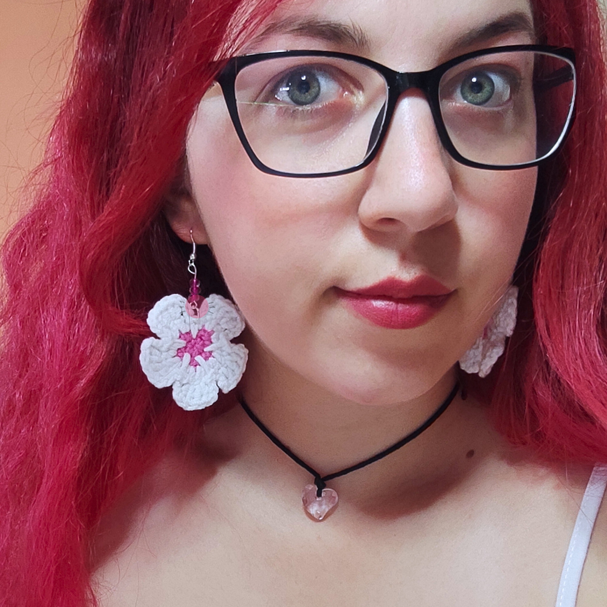 handmade crochet flower earrings displayed on yarn