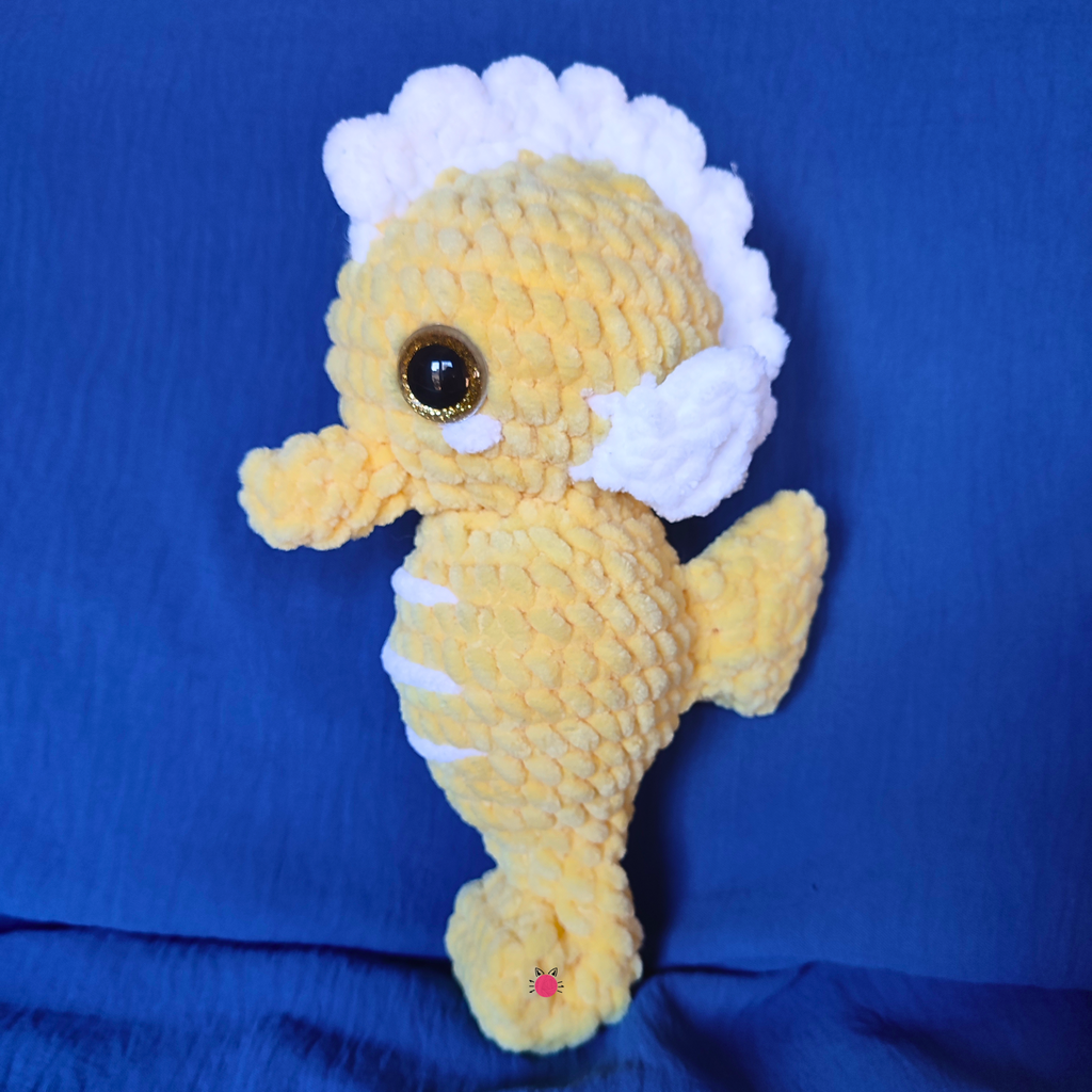 Crochet Plush seahorse toy on a blue background